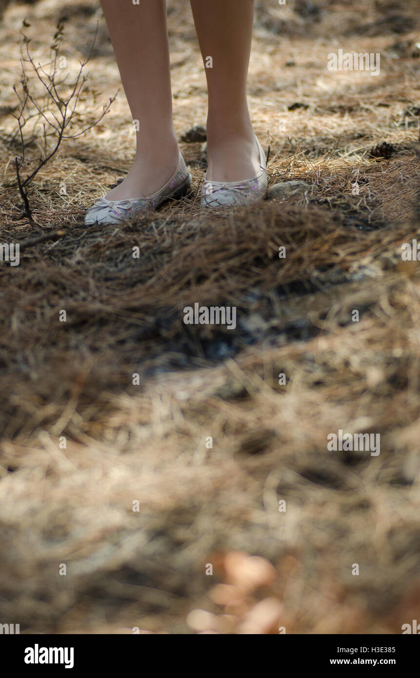 Close up of a young woman's feet walking in the woods Stock Photo
