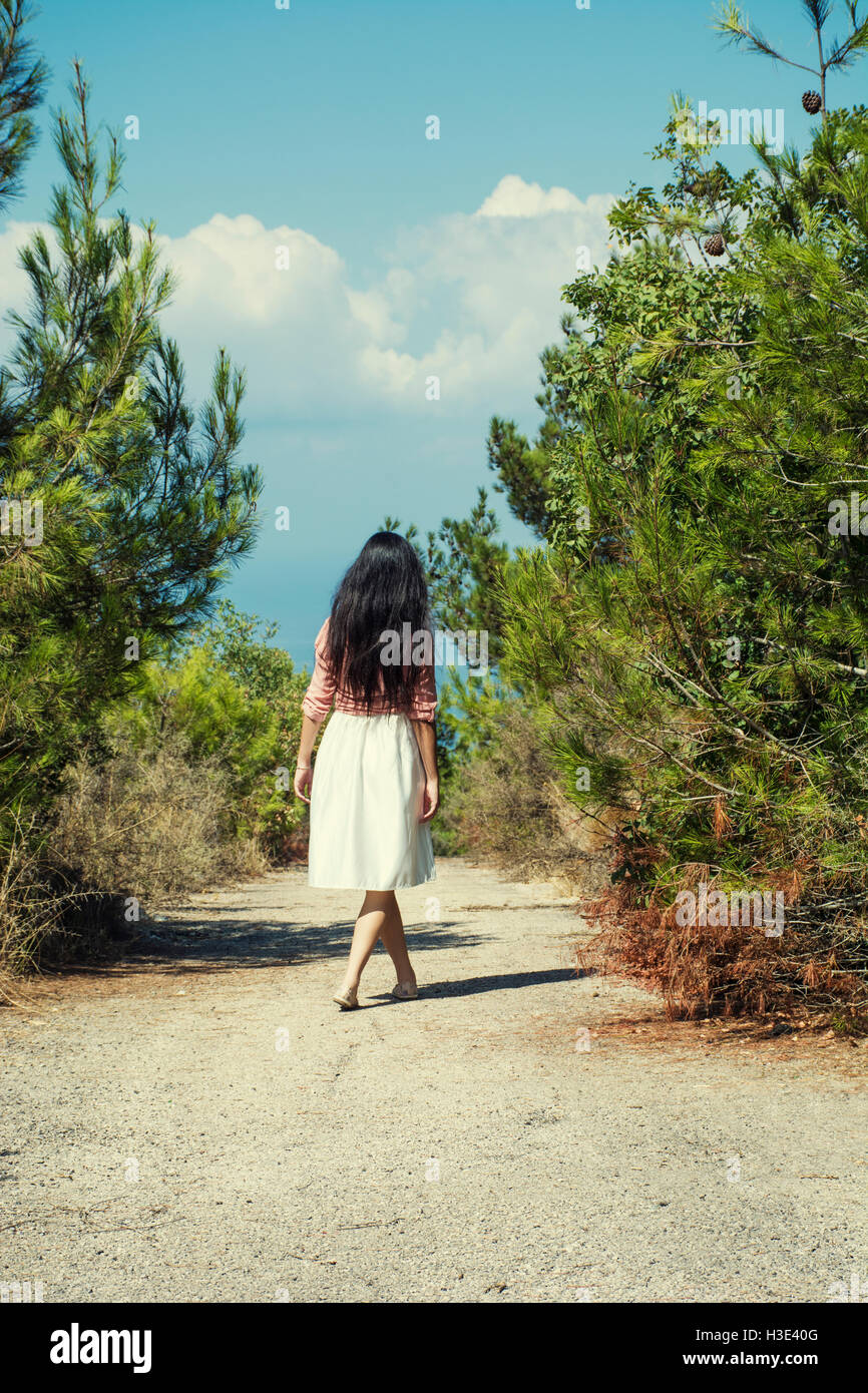 Full length of a female figure walking in the countryside Stock Photo