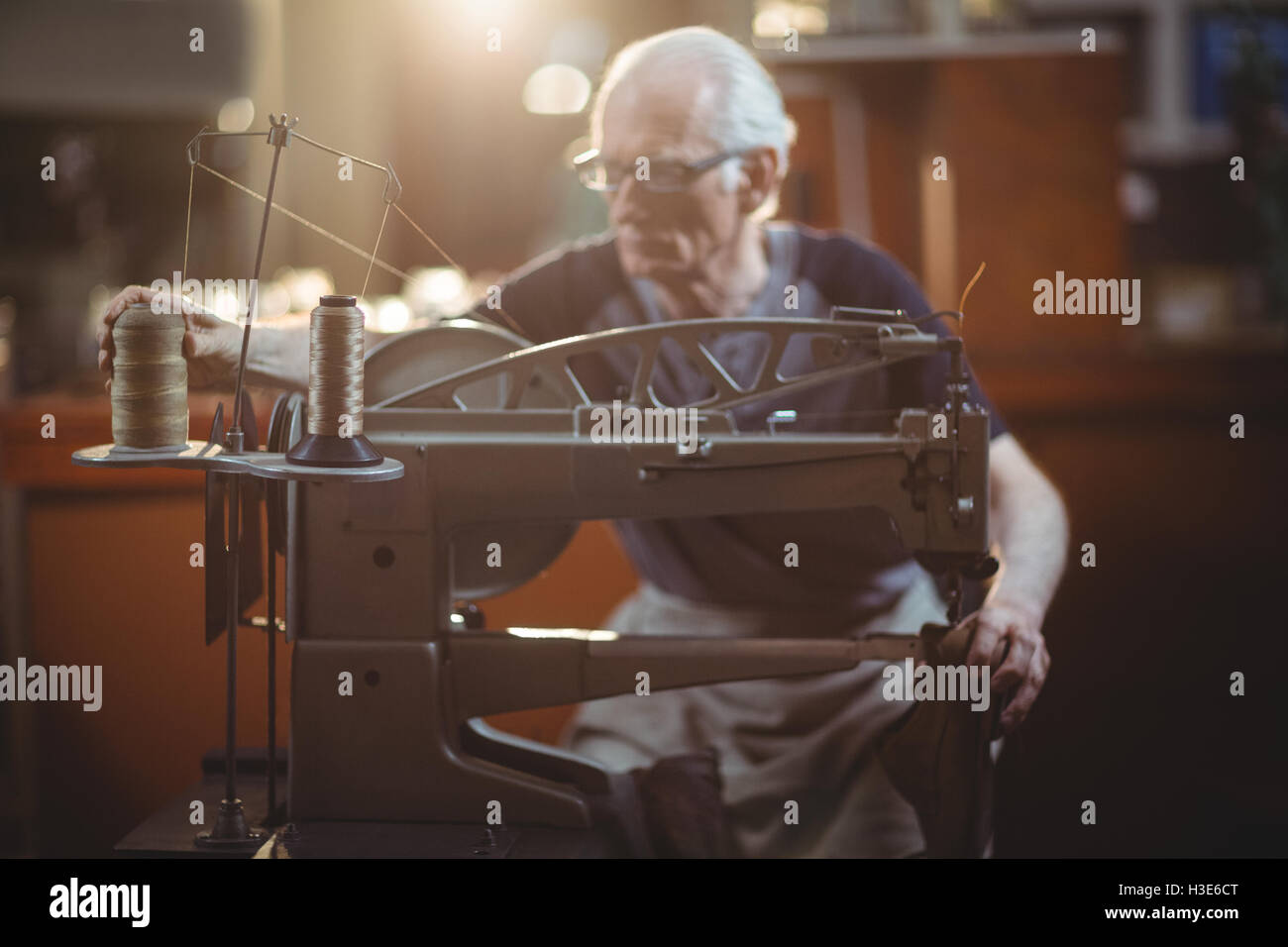 Shoemaker using sewing machine Stock Photo Alamy