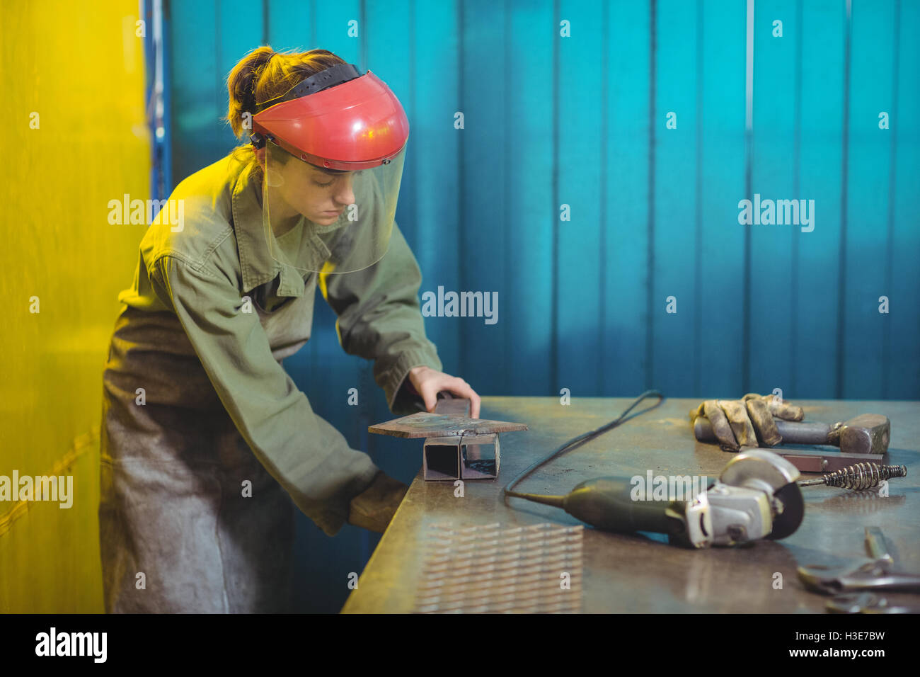 Female welder using a tool Stock Photo