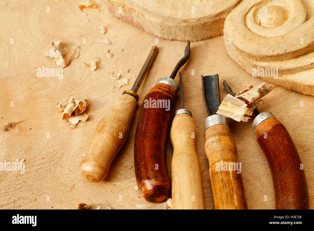 Vintage tools of woodcarving closeup on wooden background Stock Photo