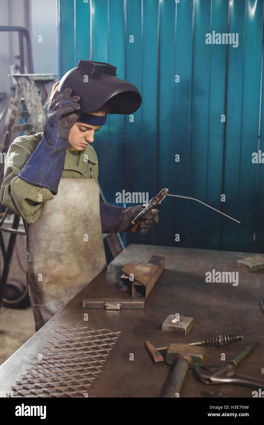 Female welder holding welding arch Stock Photo Alamy