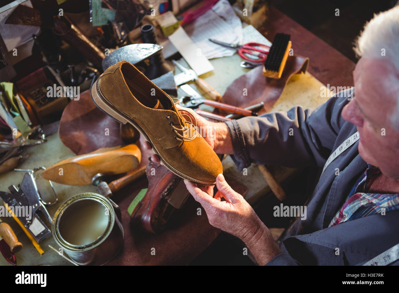 Shoemaker examining a shoe Stock Photo - Alamy