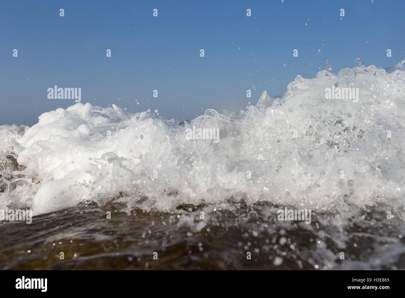 Sea wave splashing over the shore rocks with a high sea spray Stock ...