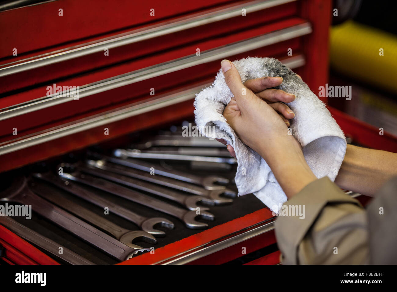 Mechanic wiping her hand with handkerchief Stock Photo