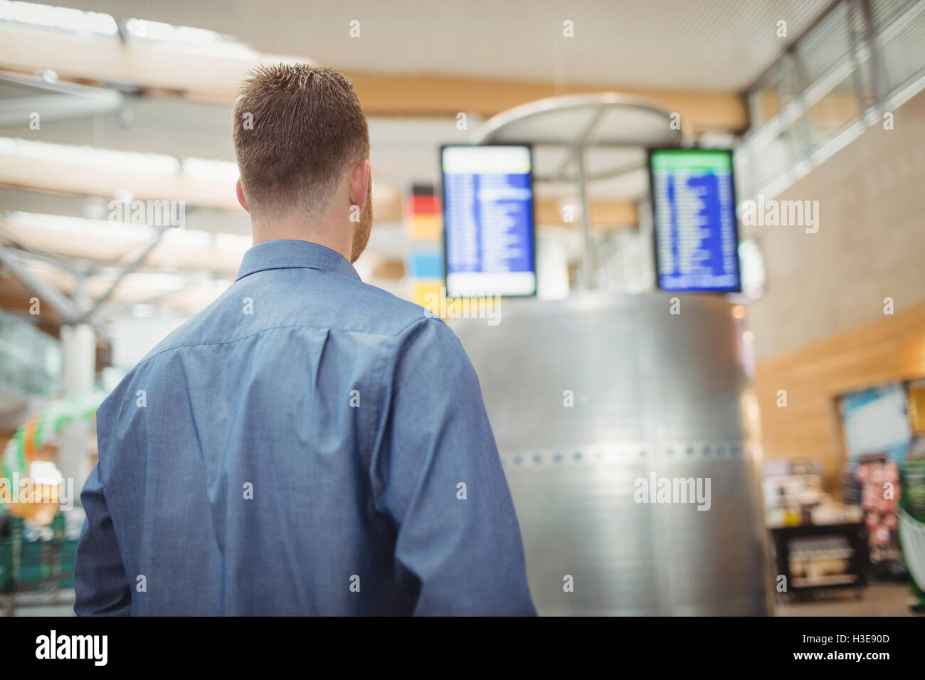 Man standing in airport terminal Stock Photo