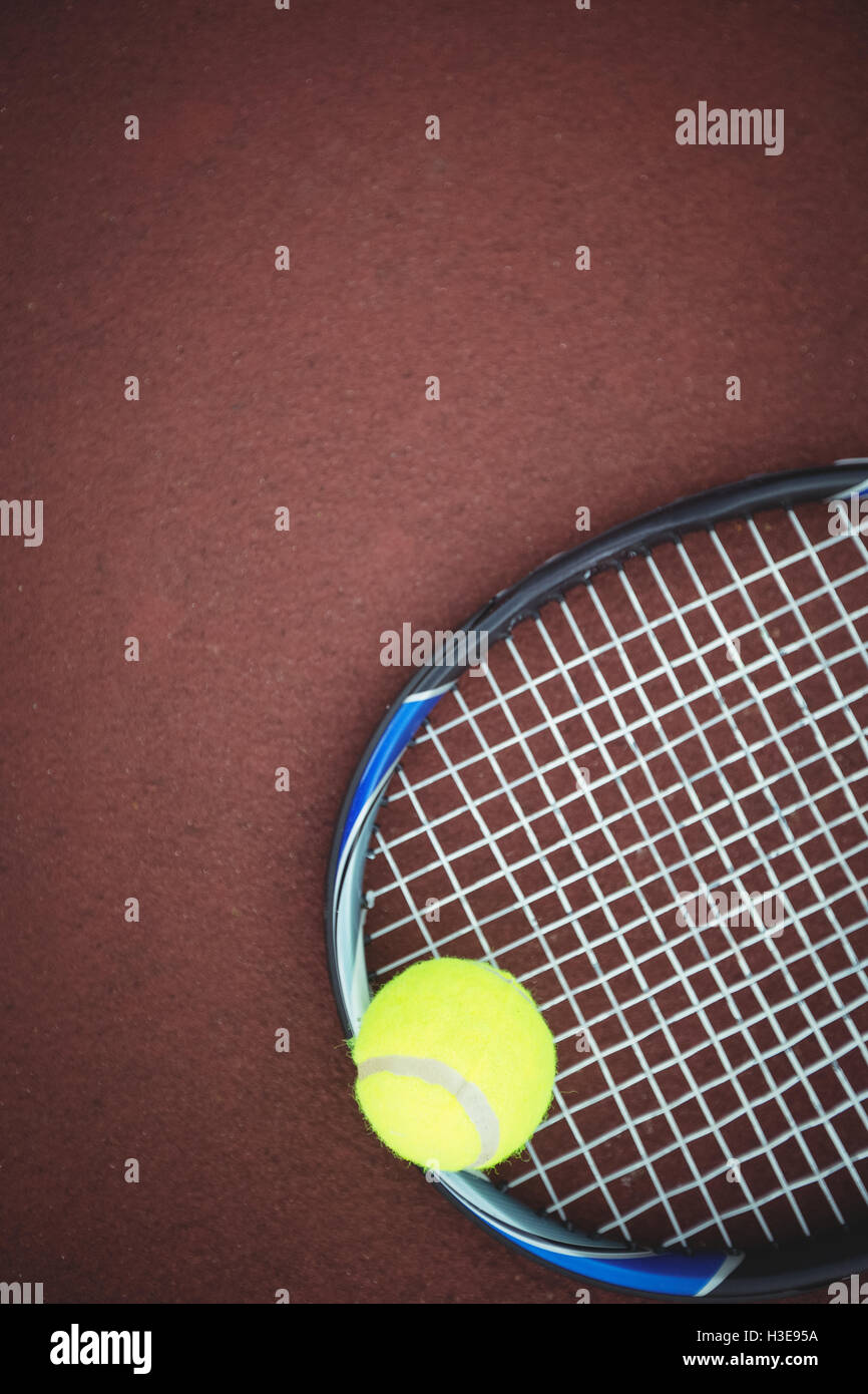 Tennis ball and racket in the court Stock Photo