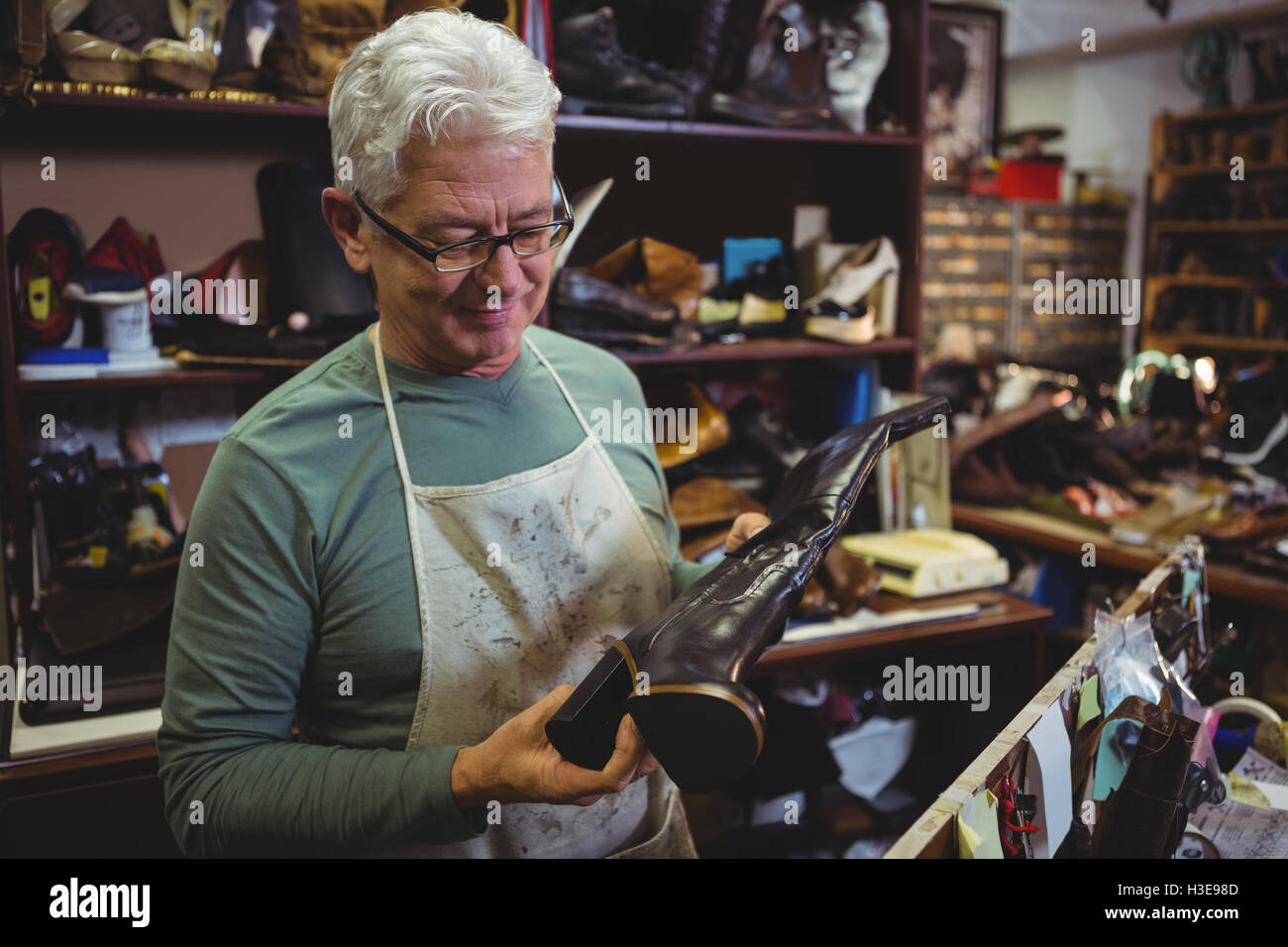 Shoemaker examining a shoe Stock Photo - Alamy