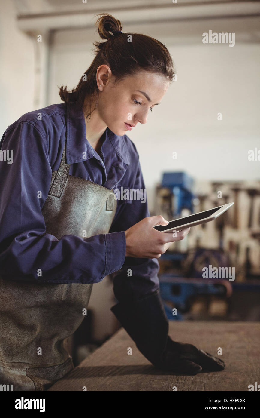 Female welder using digital tablet Stock Photo Alamy