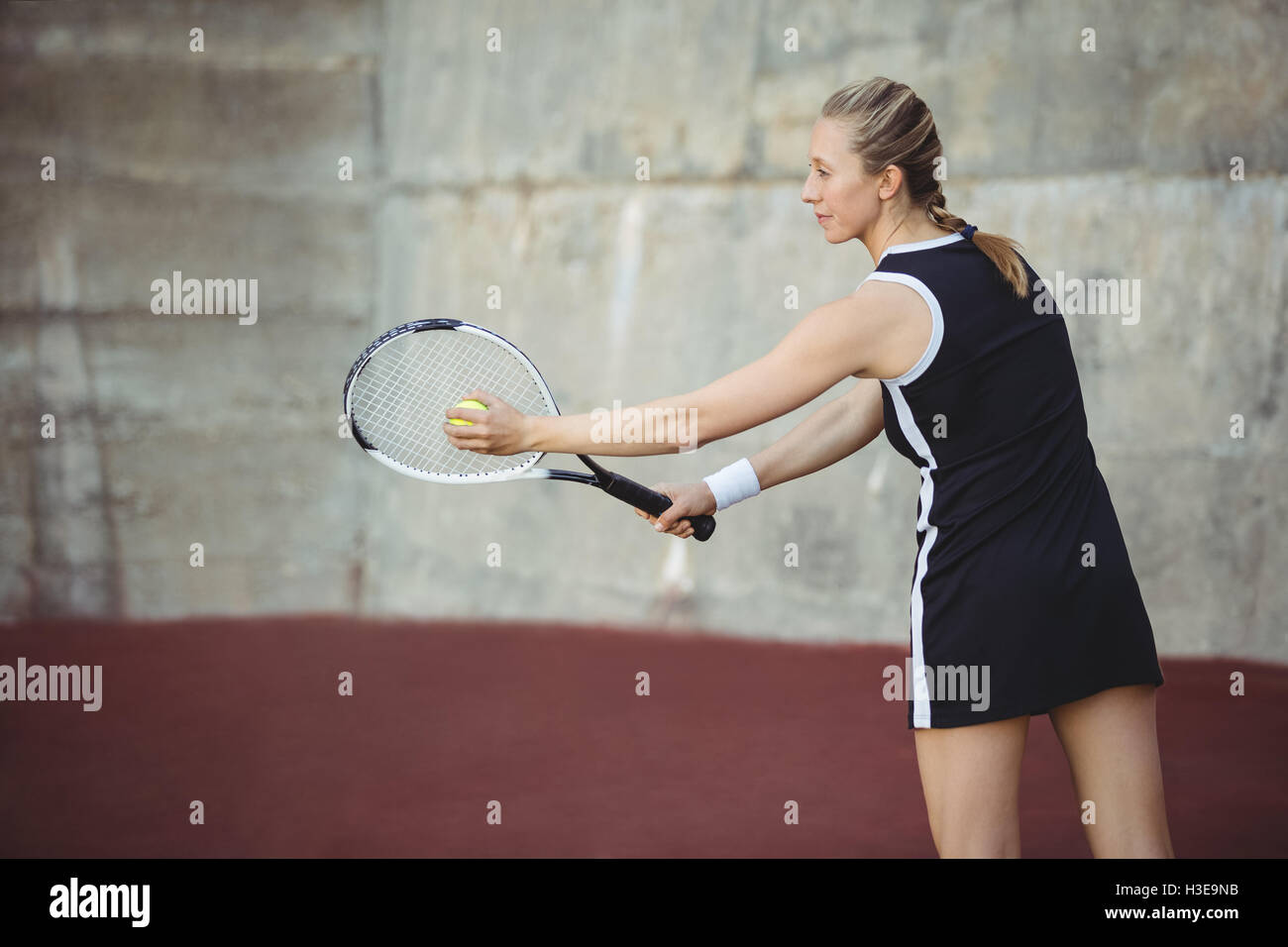 Woman with tennis racket ready to serve Stock Photo