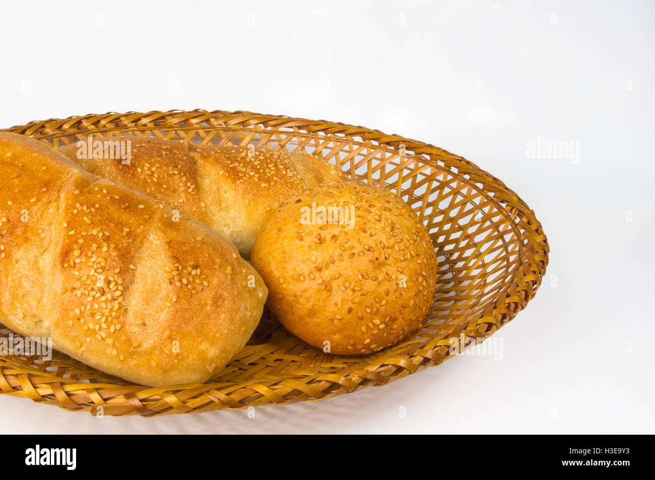 whole wheat breads and bun on a wicker plate Stock Photo - Alamy