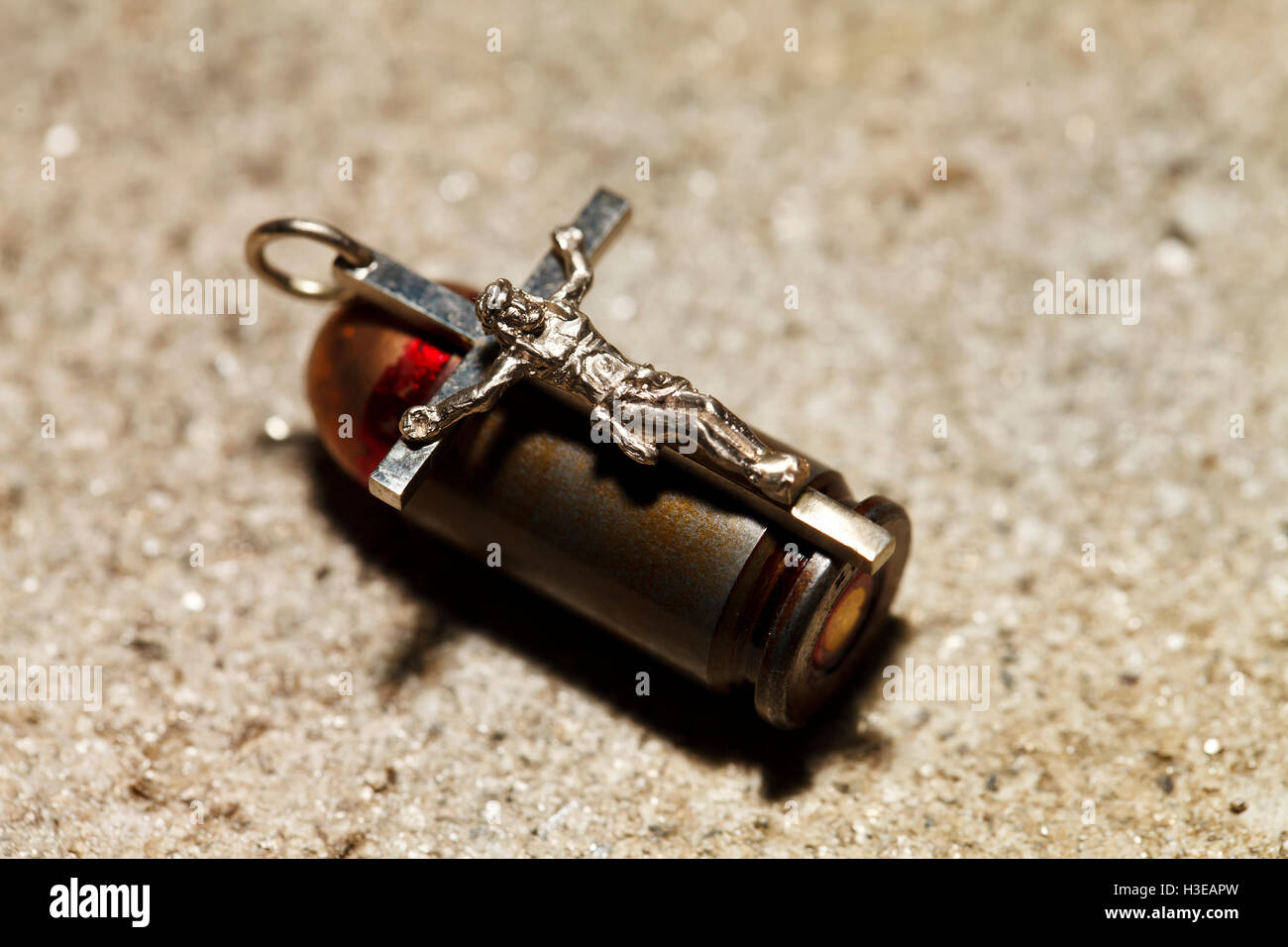 a Bullet and pectoral cross , abstract religion Stock Photo