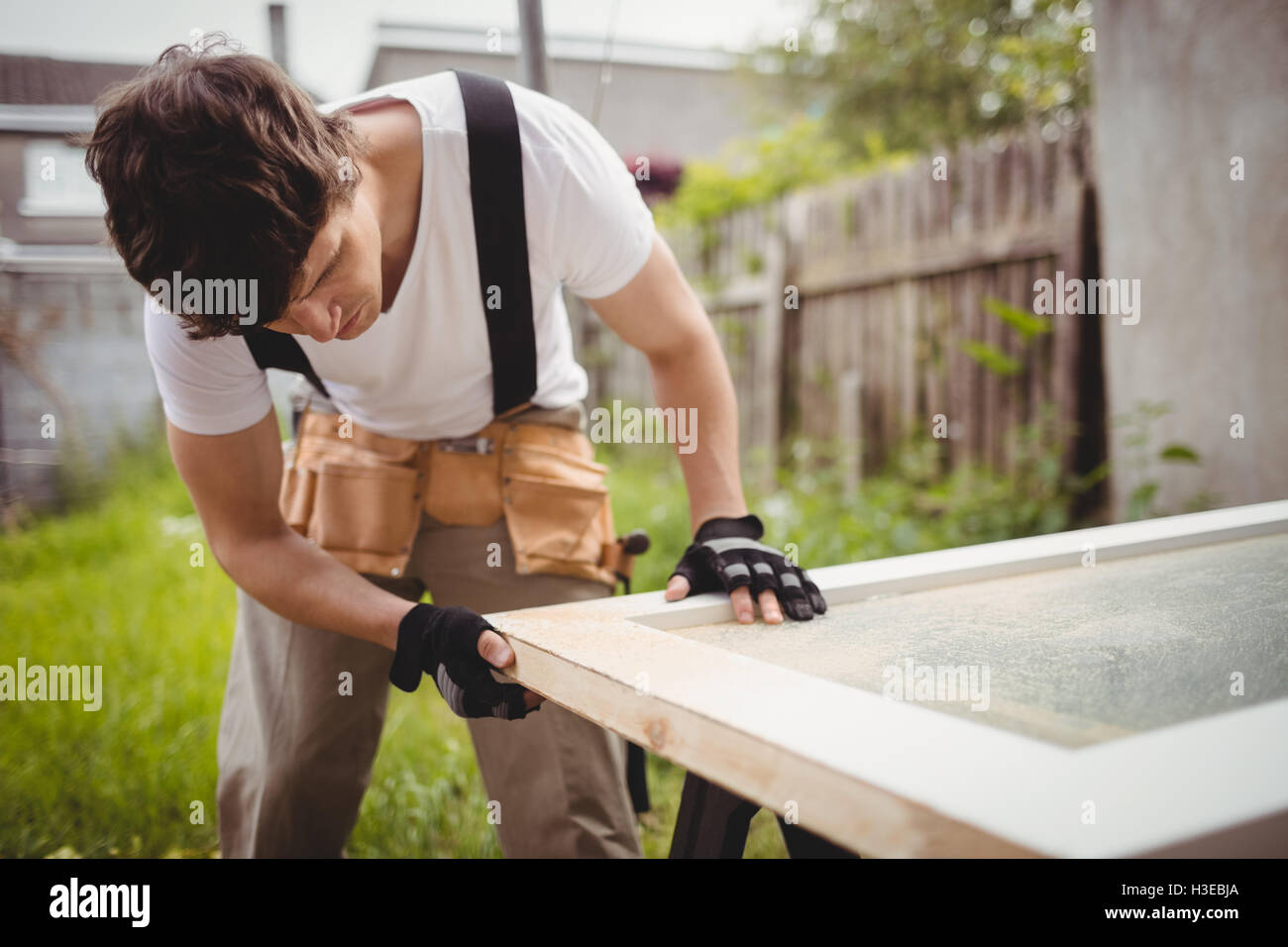 Carpenter working on a door frame Stock Photo Alamy