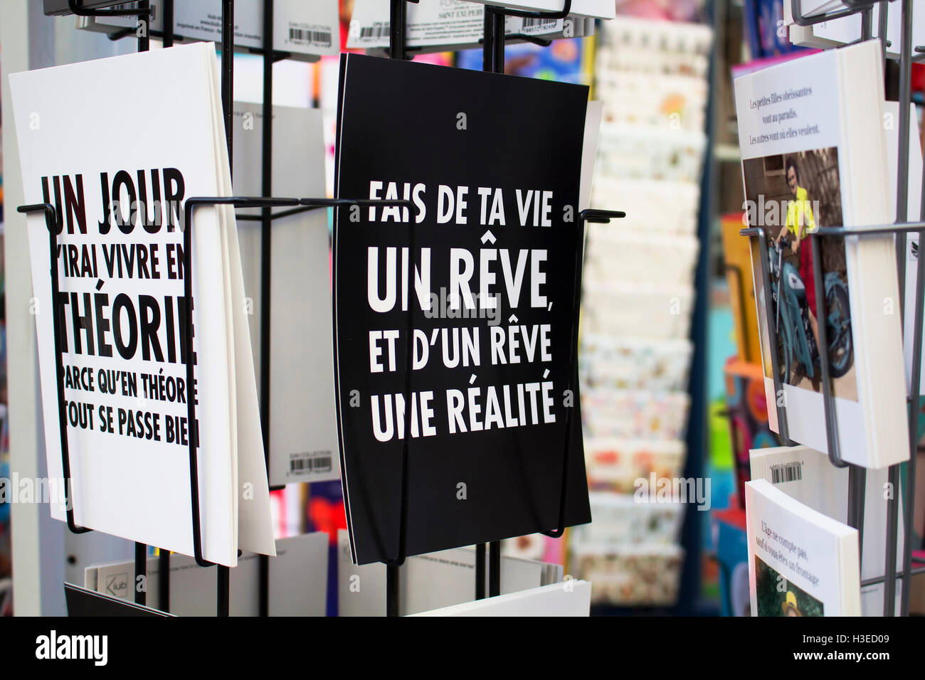 Close up view of French postcards on racks about humour on Rue Montorgueil street in Paris. Stock Photo