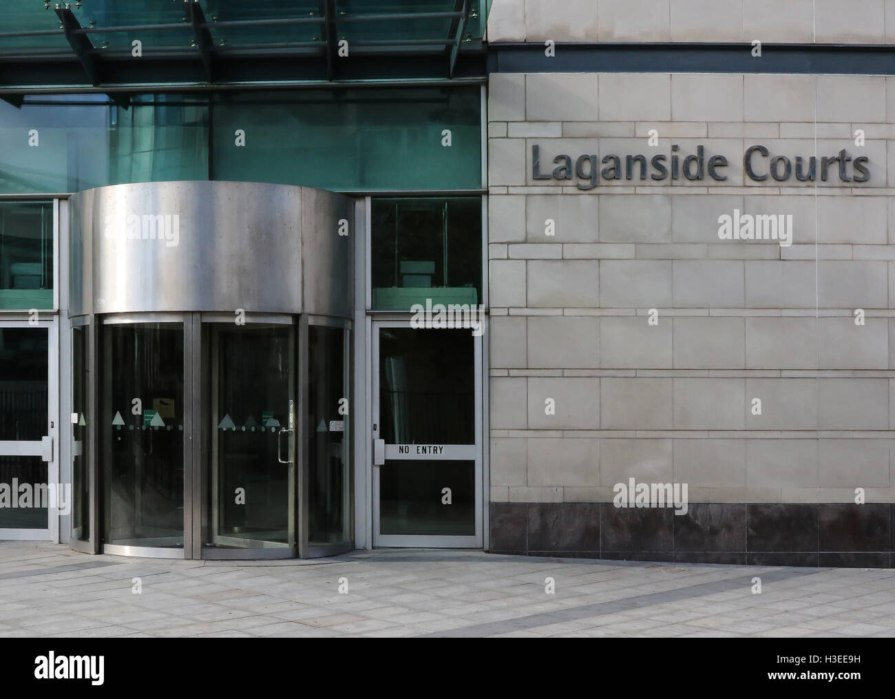 Modern revolving door entrance to UK courthouse and name sign at Laganside Courts, Oxford Street, Belfast Stock Photo