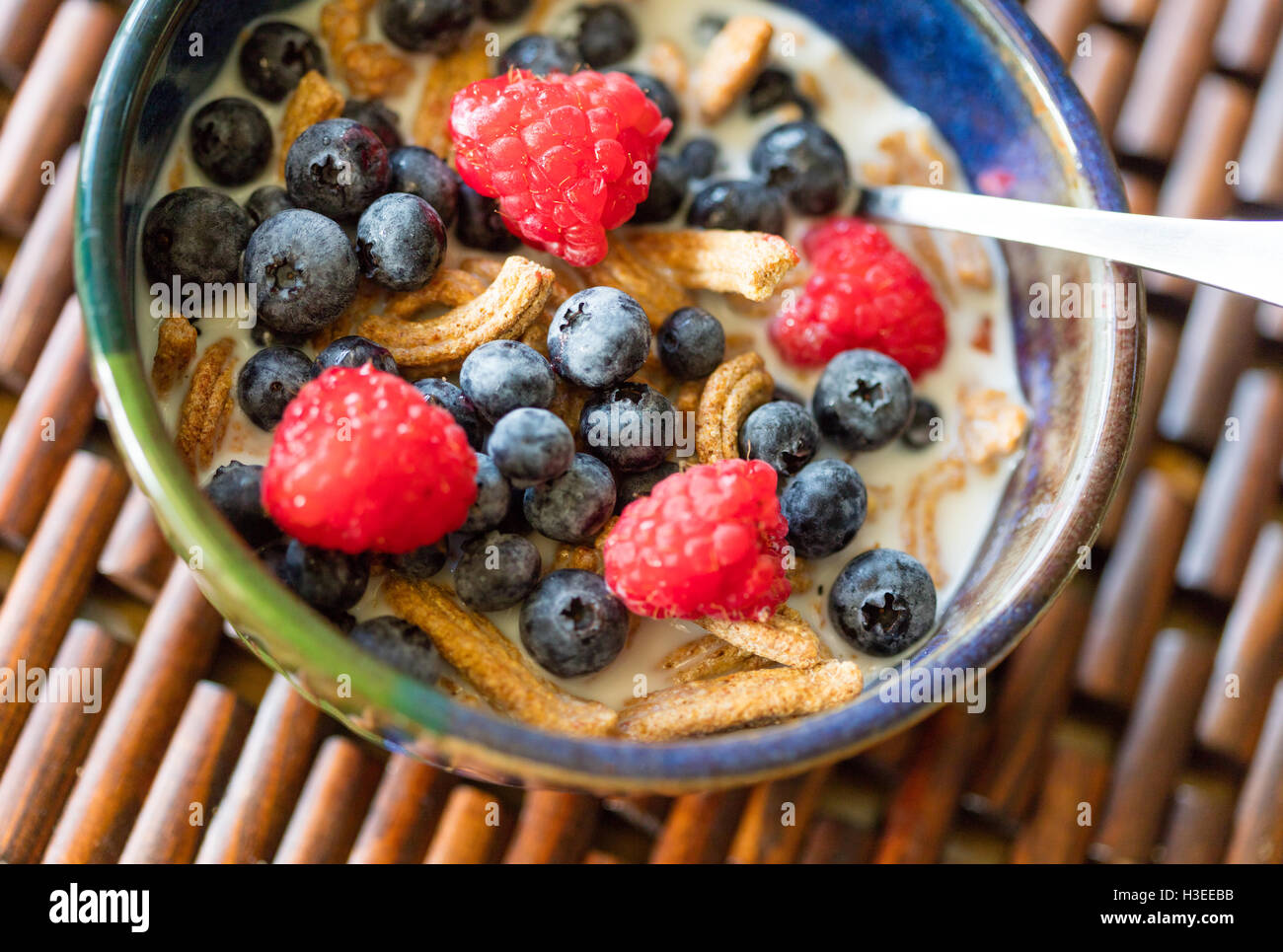 High fiber cereal with fresh blueberries and raspberries Stock Photo