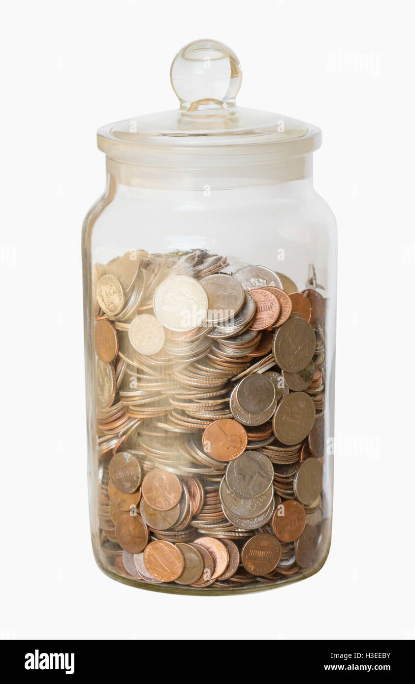 A large collection of loose change in a big glass jar with a lid