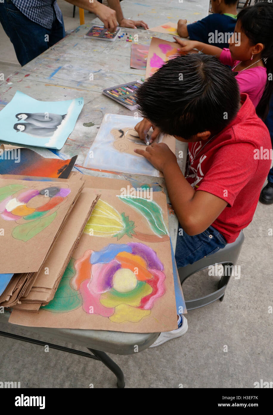 Mexican kids doing artwork during a local neighborhood festival in Acapulco, Mexico. Stock Photo