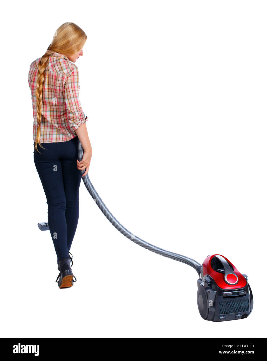 Rear view of a woman with a vacuum cleaner. She is busy cleaning. Rear view people collection. backside view of person. Isolated over white background. Long-haired blonde vacuums. Stock Photo