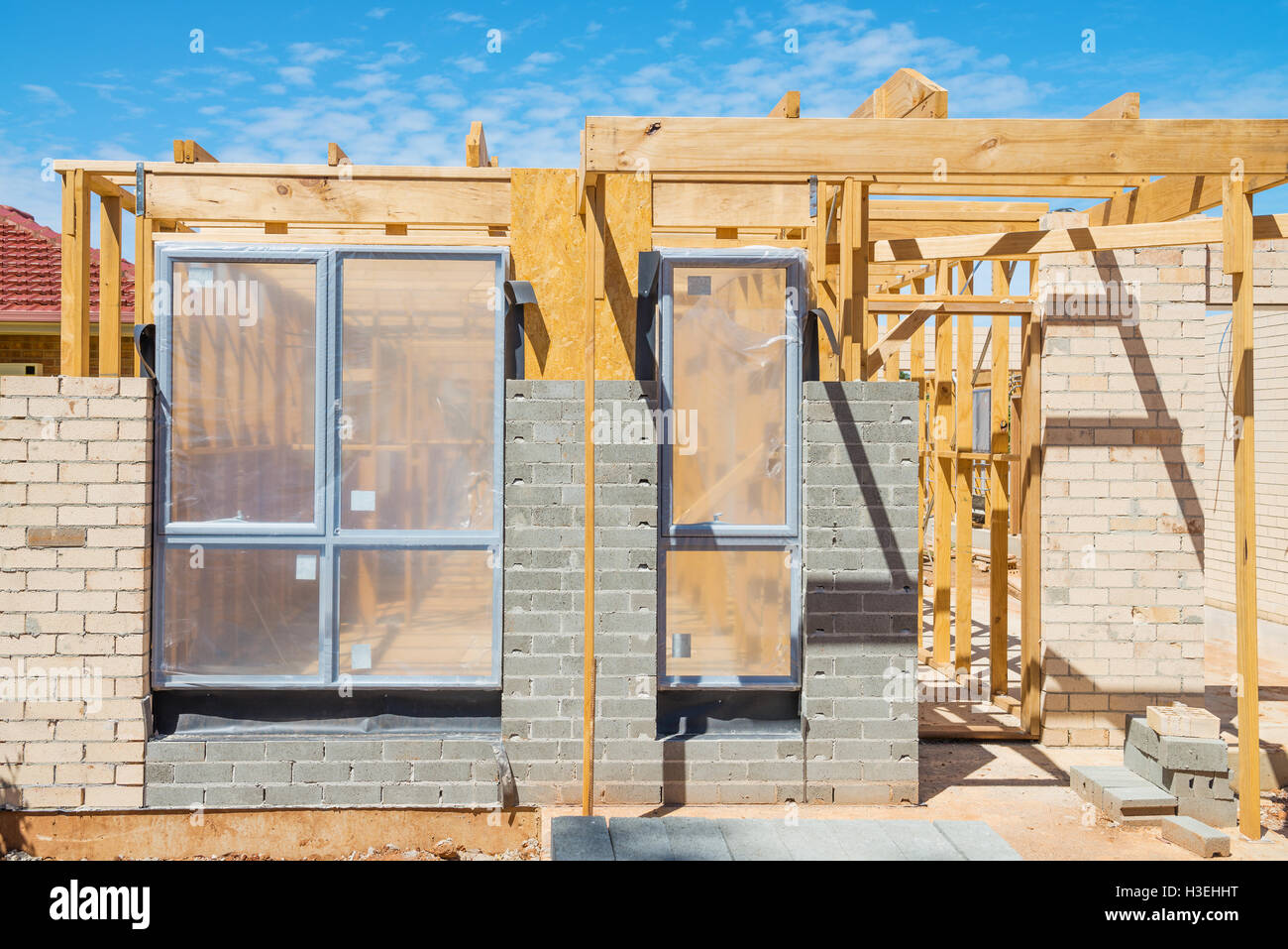 New residential construction home framing against a blue sky. Stock Photo