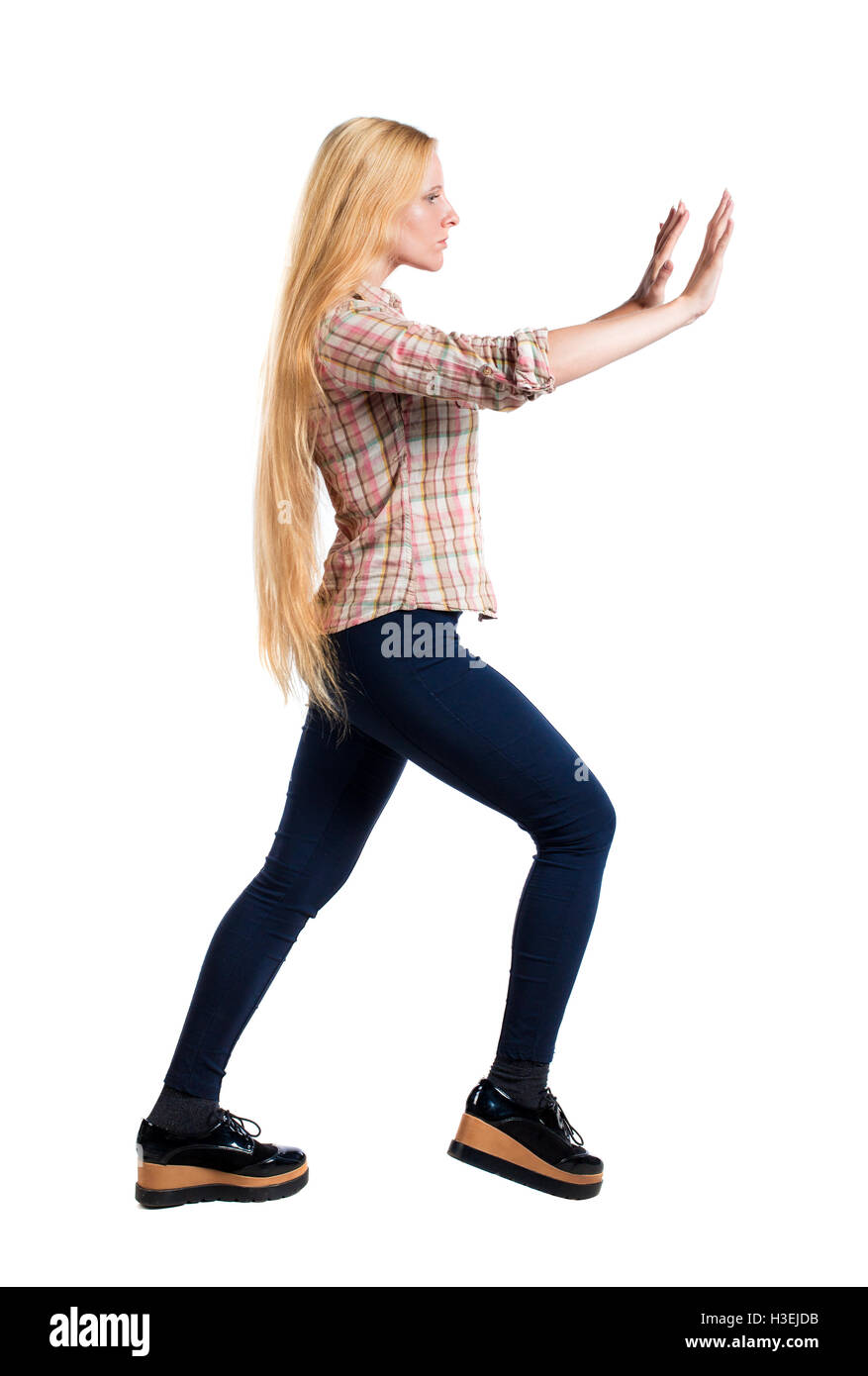 Pushing Back View back view of woman pushes wall. Isolated over white background. Rear ...