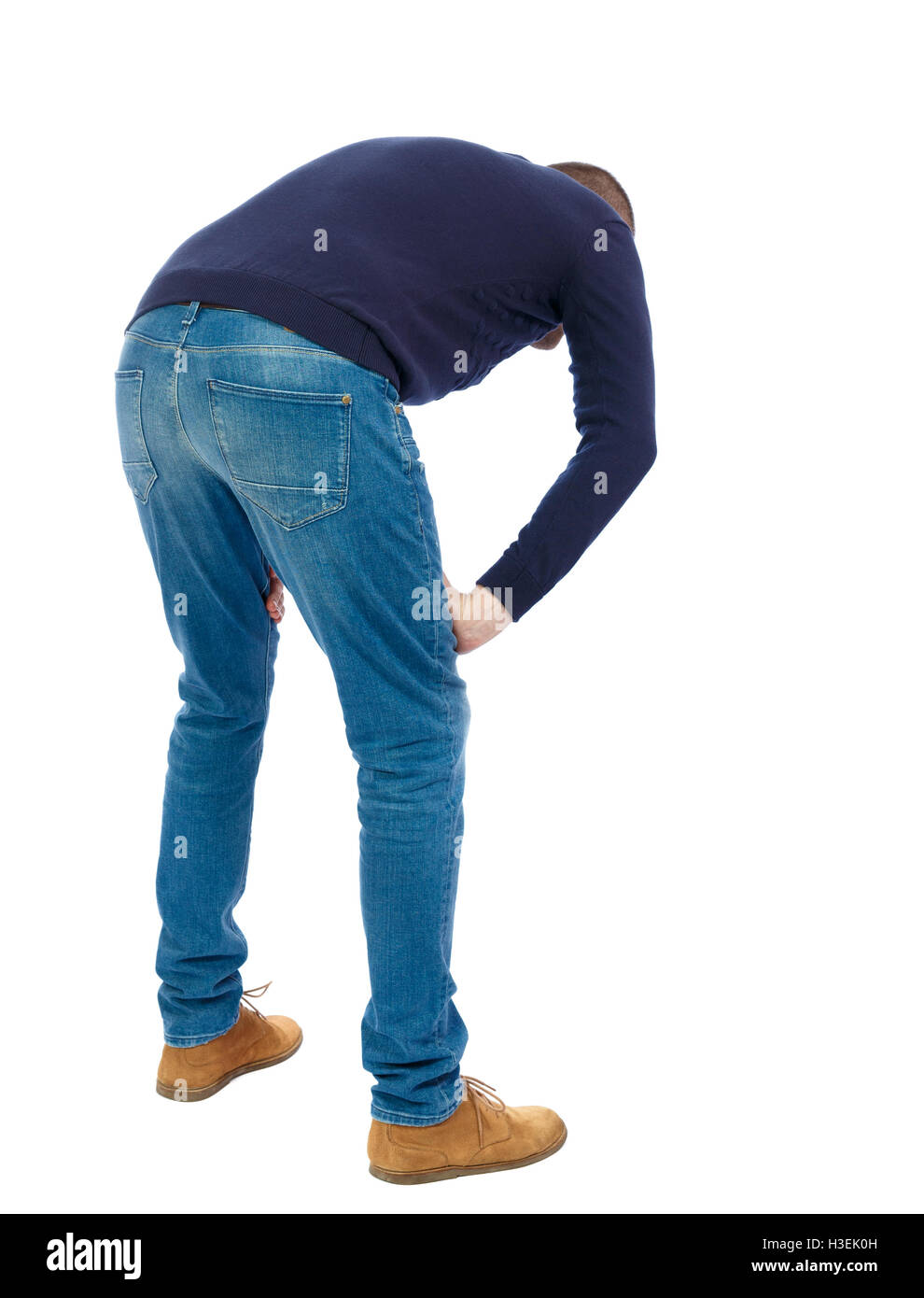 Back view of a man who rests in his hands leaning. Standing young guy. Rear view people collection. backside view of person. Isolated over white background. Man in warm jacket bent wearily. Stock Photo