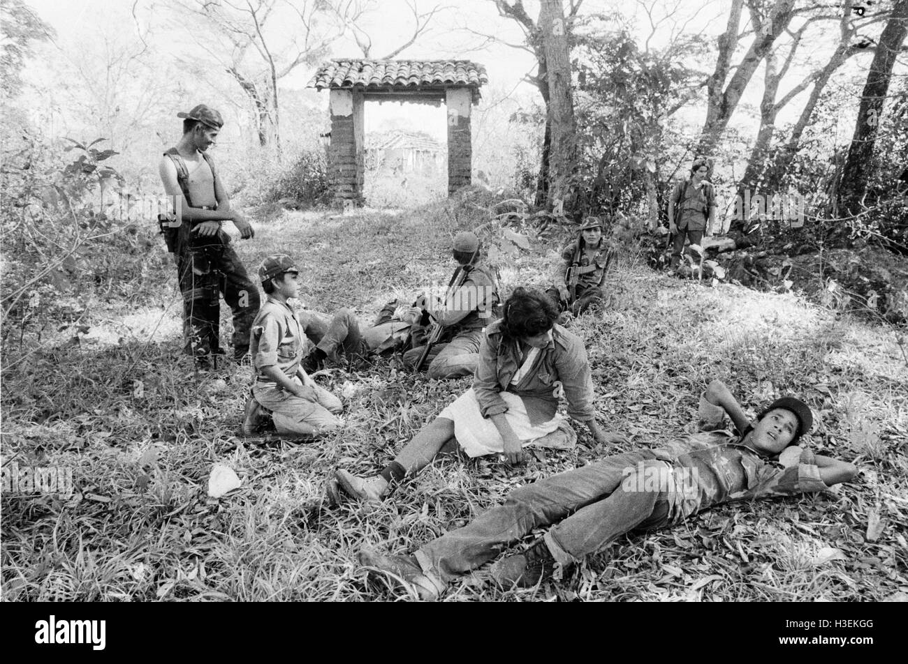 CHALATENANGO,  EL SALVADOR, FEB 1984: - Within the FPL Guerrilla's Zones of Control   A group of FPL men and women fighters rest and take water from a stream. Stock Photo