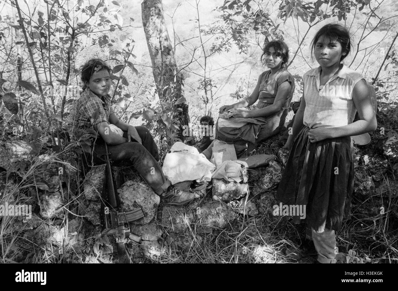 CHALATENANGO,  EL SALVADOR, FEB 1984: - Within the FPL Guerrilla's Zones of Control   A group of FPL men and women fighters rest and take water from a stream. Stock Photo