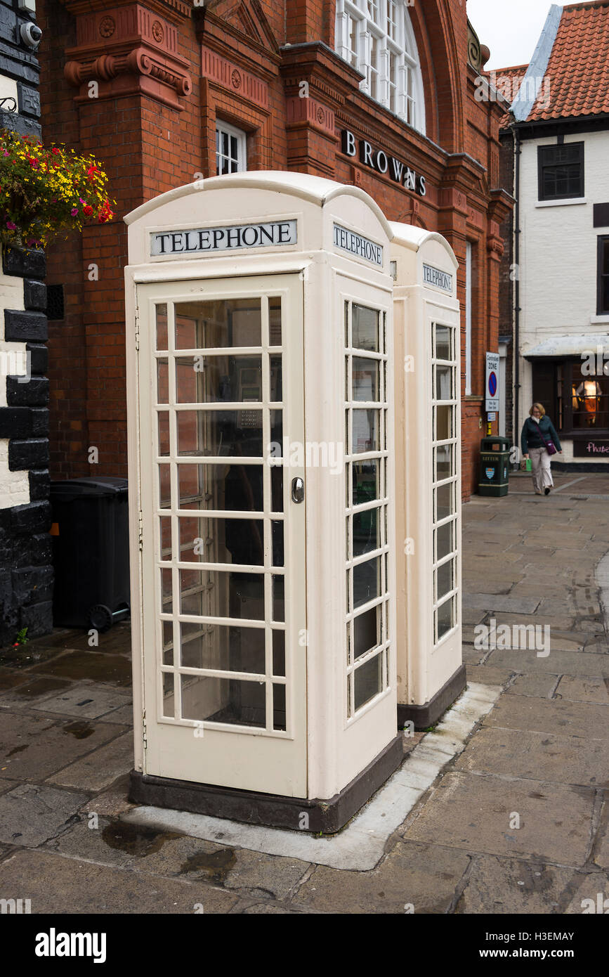 Two White Telephone Boxes of Kingston Communications Outside Browns Department Store in Market Square Beverley Yorkshire England United Kingdom UK Stock Photo