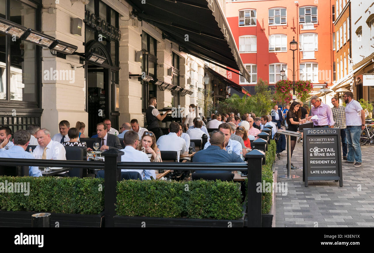 People dining at lunchtime at Piccolino Restaurant in Piccadilly London on a warm summers day. Stock Photo