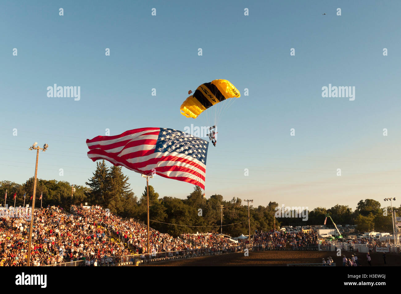 FOLSOM, CA, USA - JULY 4, 2010: US Army Skydiver landing with US flag at Folsom rodeo Stock Photo