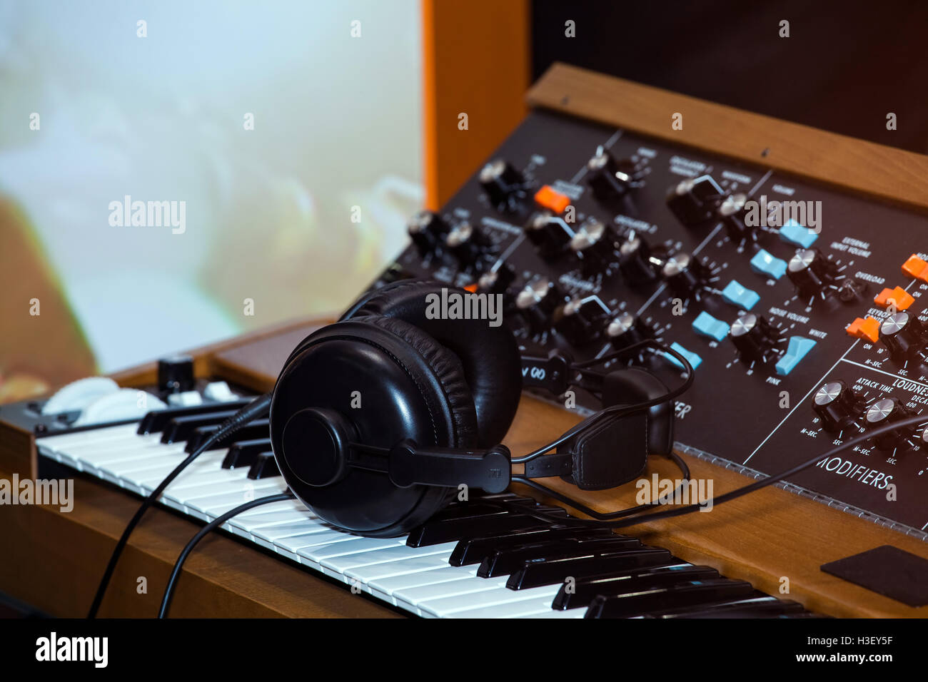 Black headphones on the keyboard piano Stock Photo Alamy