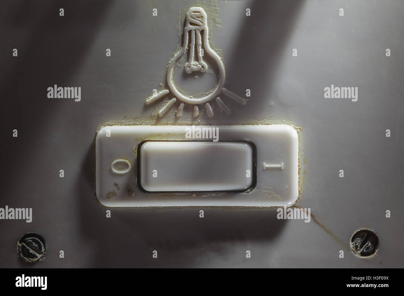 Details of an old dirty plastic switch for turning light on or off. Stock Photo