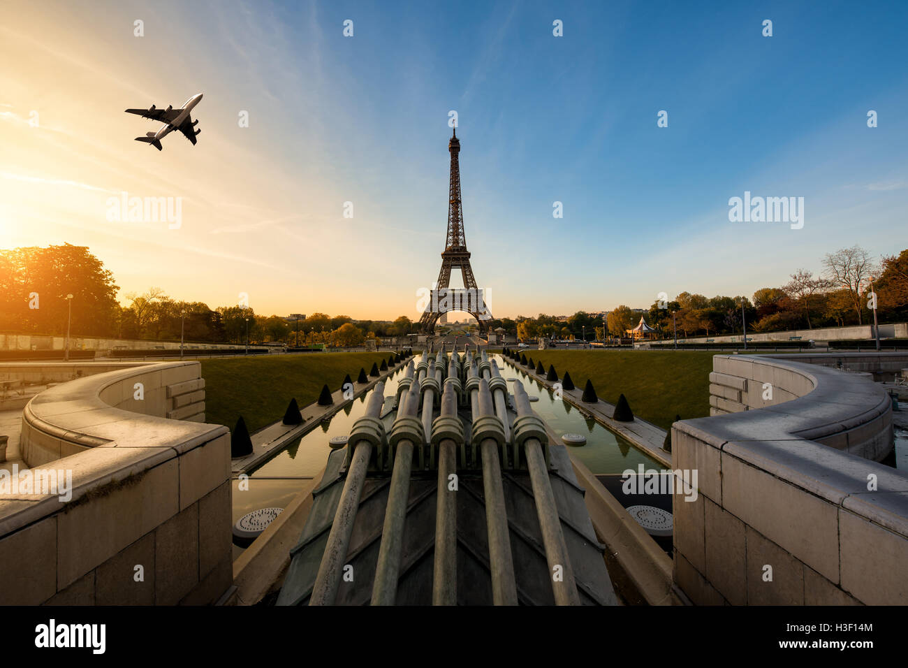 Airplane flying over Eiffel Tower in morning, Paris, France. Eiffel Tower is international landmark in Paris, France Stock Photo