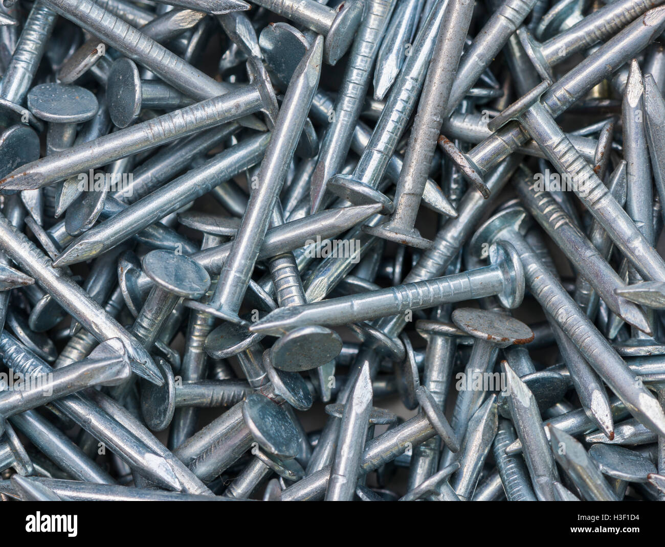 English alphabet from small iron nails on a white isolated background.  Industrial pattern of thin nails for fasteners. bright numeral for design  Stock Photo - Alamy