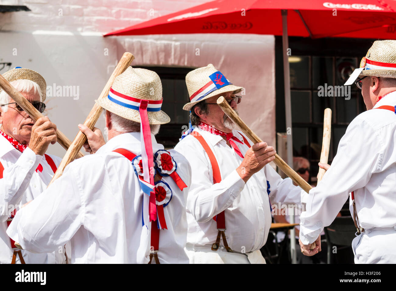 Broadstairs Folk Week. Traditional English Folk dancers, Hartley Morris side dancing and bashing poles together, Cotswold Style. Close up. Stock Photo