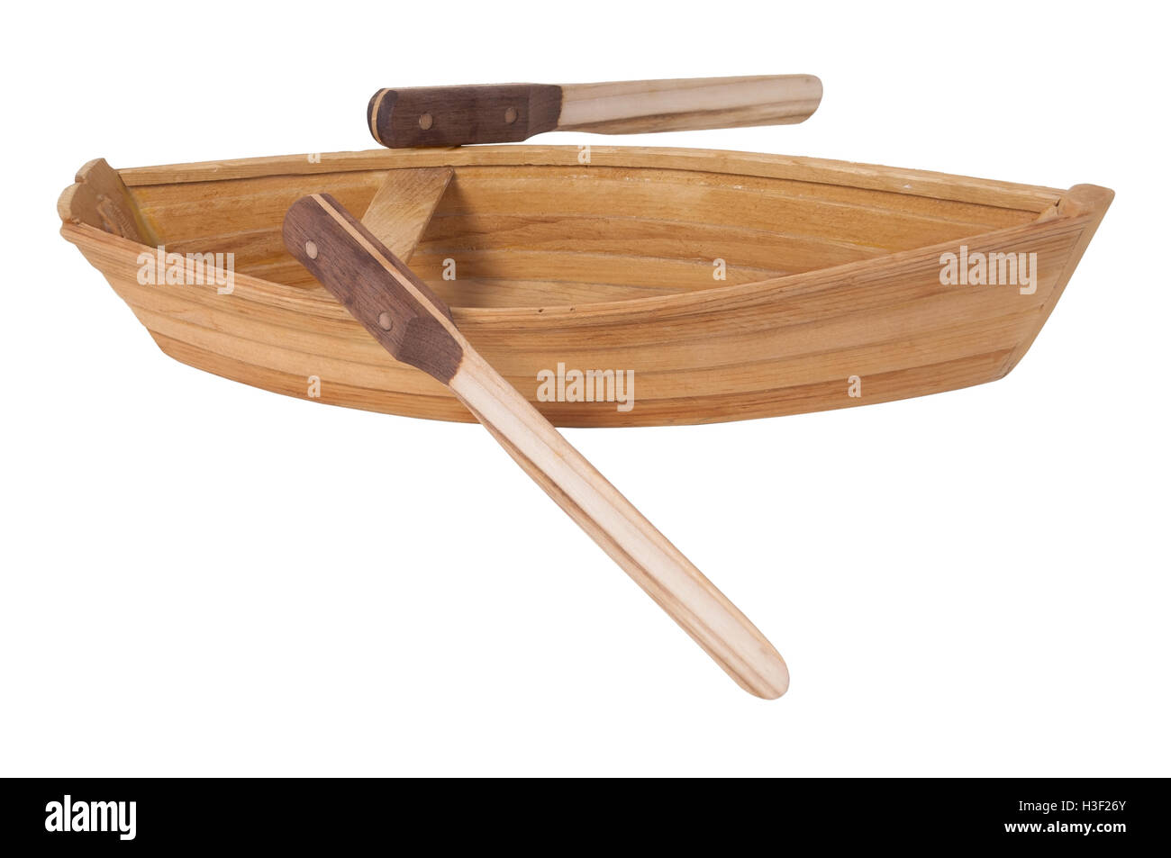 Wooden row boat with two toned wooden oars - path included Stock Photo