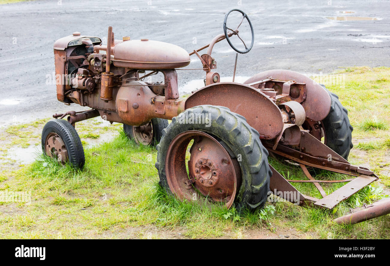 Old abandoned tractor in a field on Iceland Stock Photo - Alamy