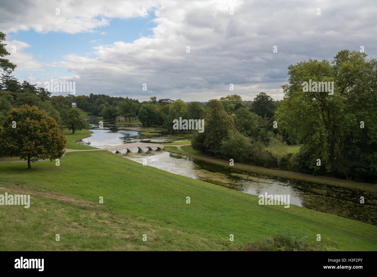 Landscape view of Painshill Park in Surrey, England including the five arch bridge over the lake Stock Photo