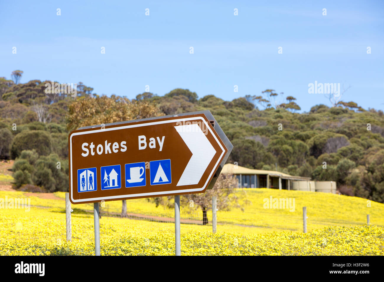 Road sign for Stokes Bay with logos for facilities, Kangaroo Island,South Australia Stock Photo