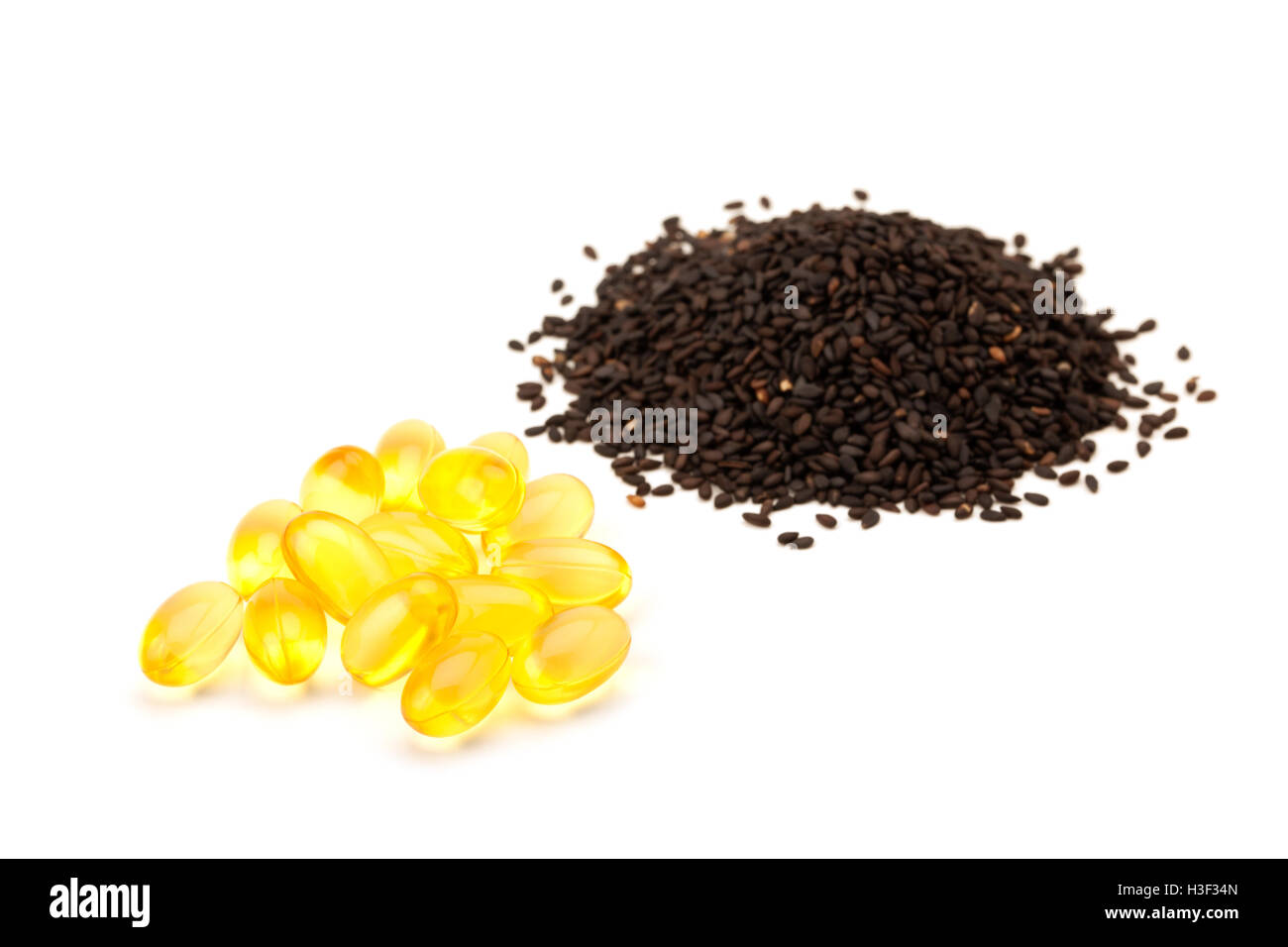 black sesame seeds and sesame oil capsule isolated on white background