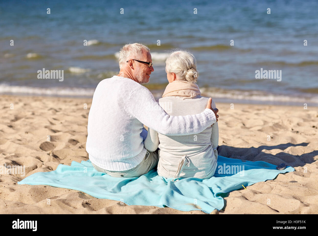 happy senior couple hugging on summer beach Stock Photo - Alamy