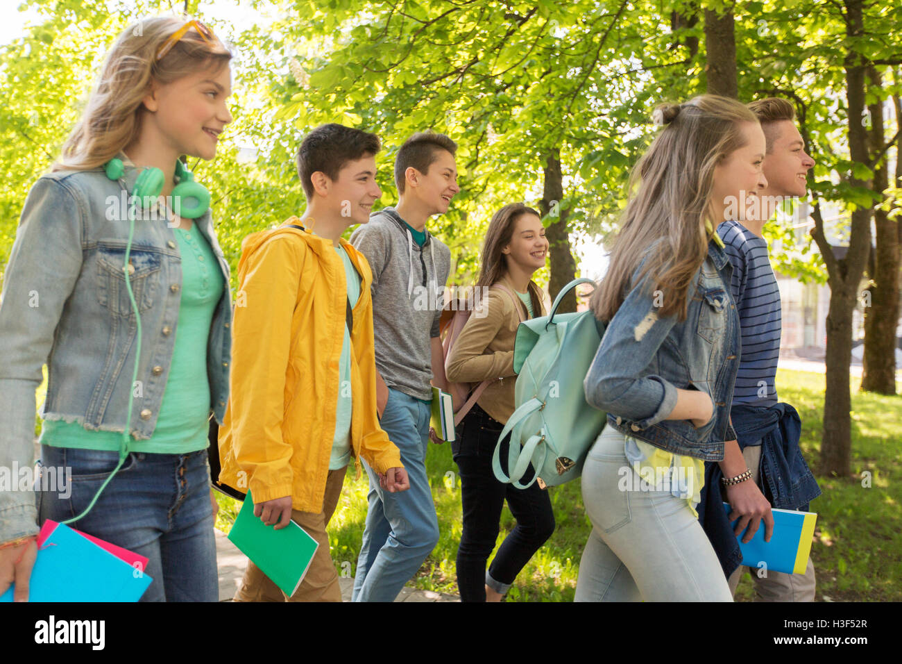 group of happy teenage students walking outdoors Stock Photo - Alamy