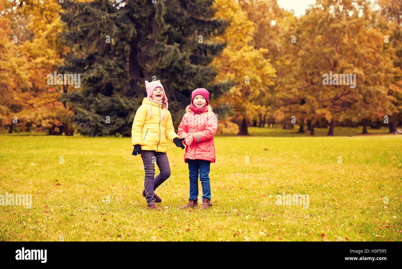 two happy little girls in autumn park Stock Photo - Alamy