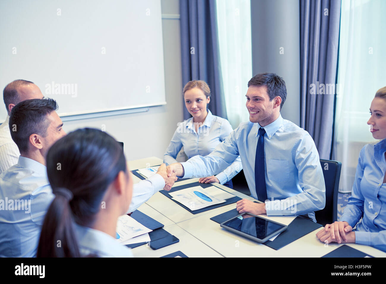 group of smiling business people meeting in office Stock Photo - Alamy