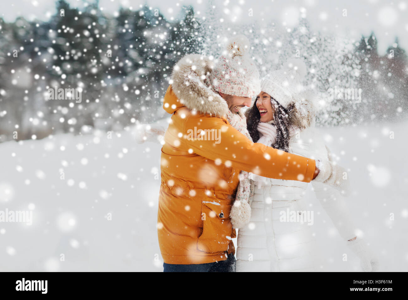 happy couple hugging and laughing in winter Stock Photo - Alamy