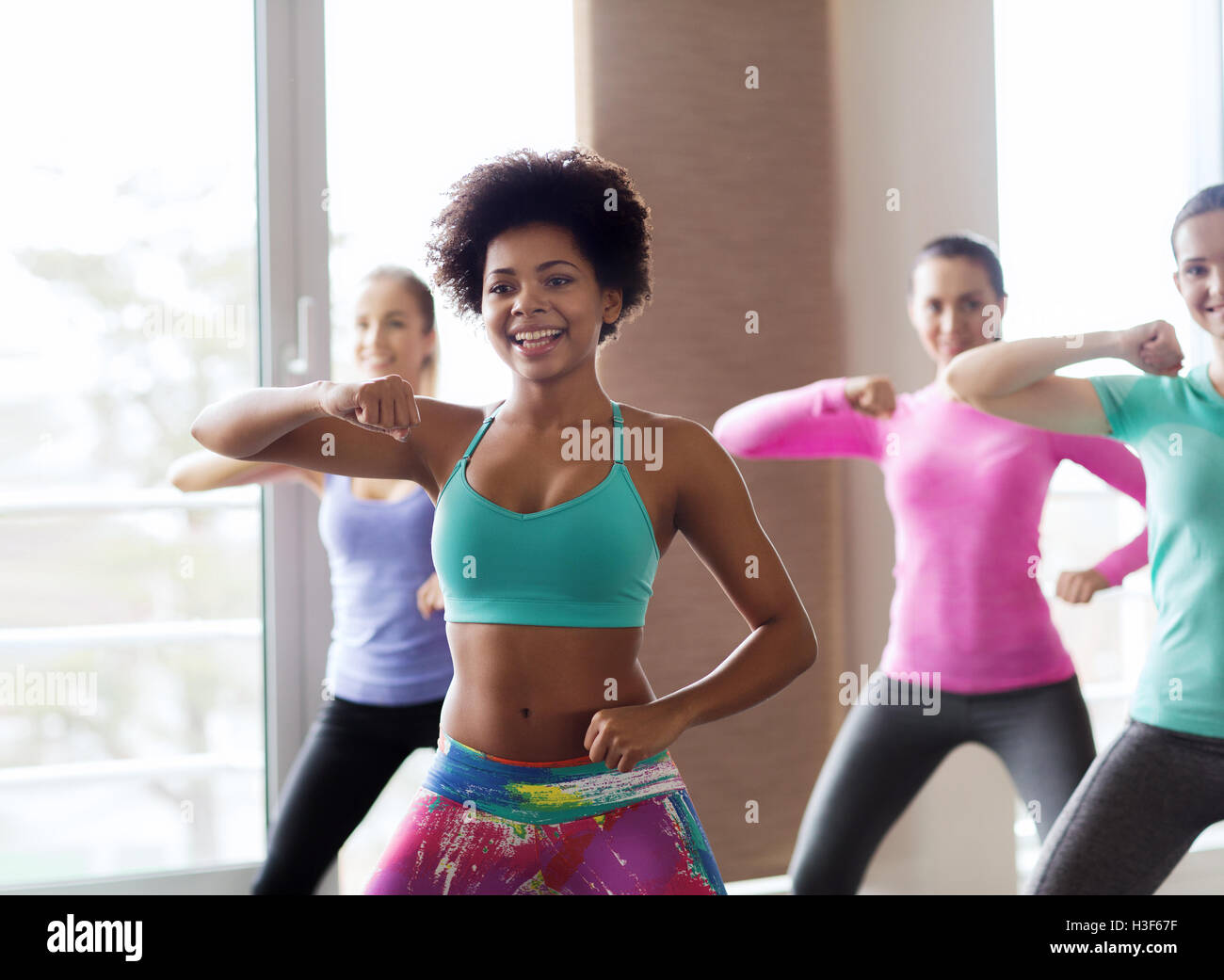 group of smiling people dancing in gym or studio Stock Photo Alamy