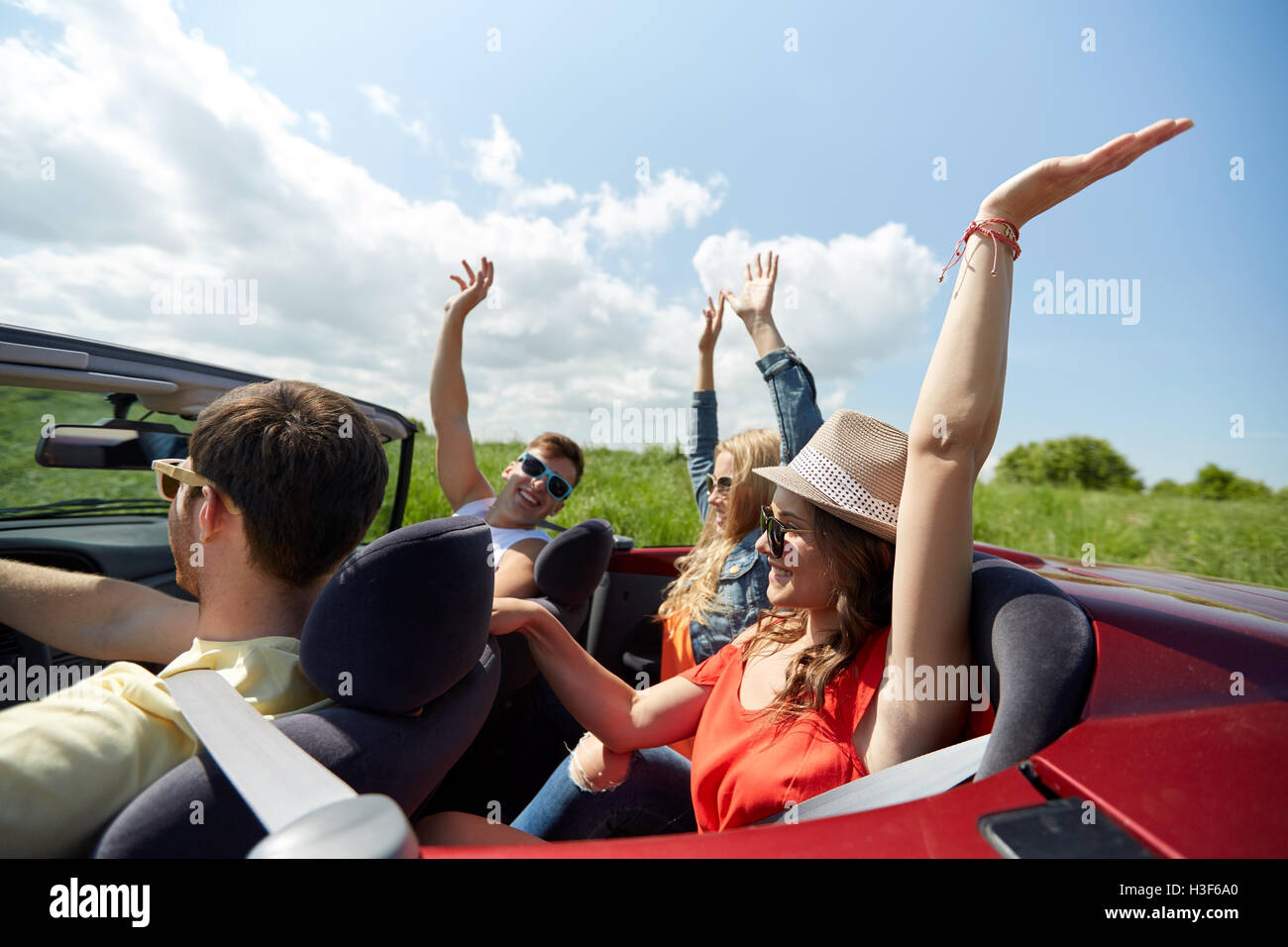 happy friends driving in cabriolet car at country Stock Photo Alamy