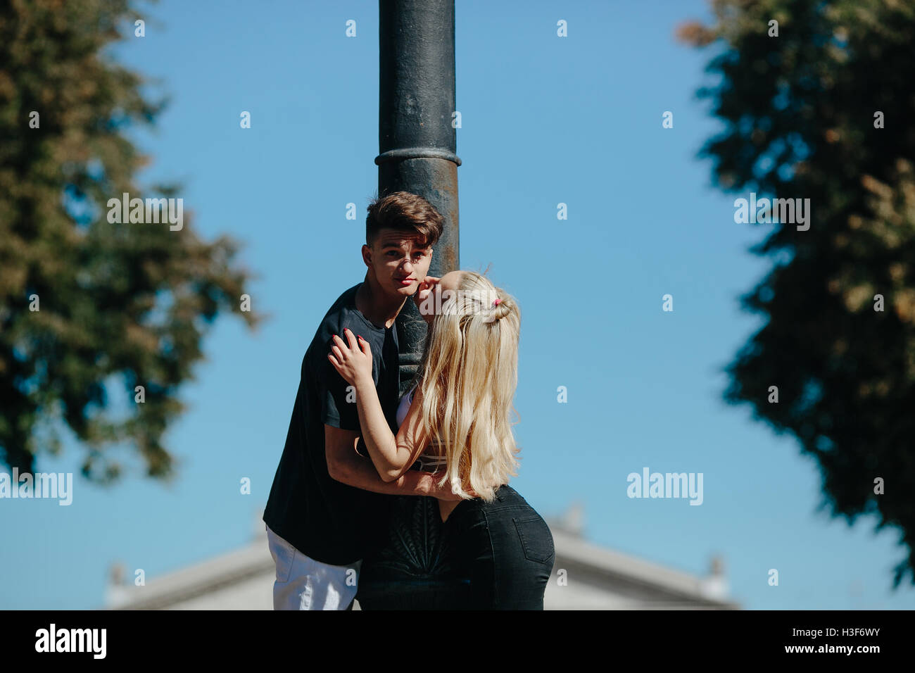 girl kissing a guy on the city street Stock Photo - Alamy