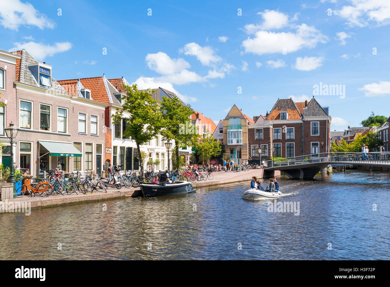 People in boat on Stille Rhine canal in old town of Leiden, South Holland, Netherlands Stock Photo